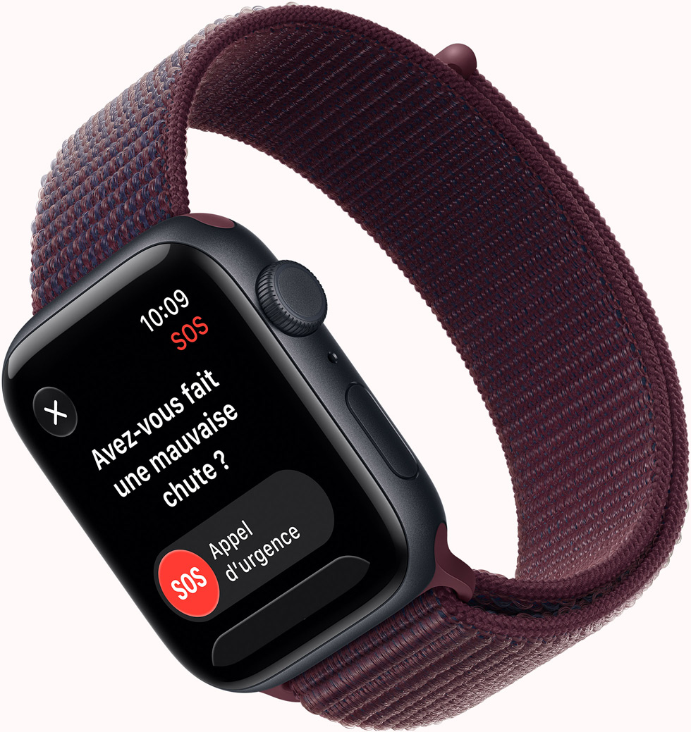 Apple Watch SE 3, screen shows SOS Fall Detection notification, emergency call button, aluminum case, midnight color, connected to Sport Loop band, burgundy color
