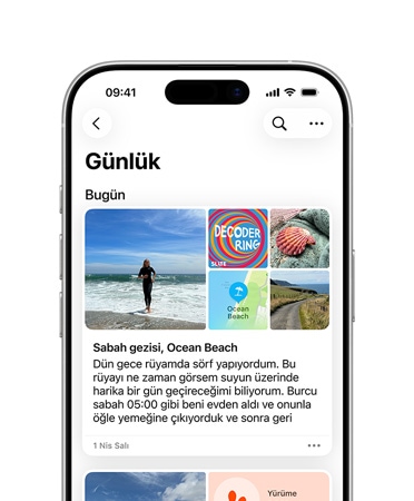 Günlük uygulaması bir günlük kayıtta açık, iPhone’da plaj gününden fotoğraflar ve rüyalar hakkında bir metin görünüyor
