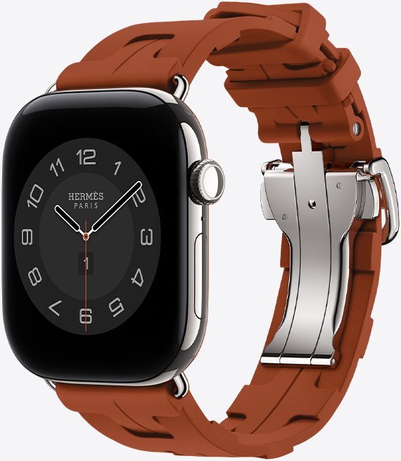 銀色鈦金屬錶殼 Apple Watch Hermès Series 12，採用 Circulaire 指針錶面 (小時、分鐘與秒針，以及多項複雜功能，包括天氣、噪音、活動記錄圓圈與巴黎時間)，右側外觀上有數位錶冠、麥克風、側邊按鈕，搭配 Cuivre 銅綠色 (棕色系) Kilim Single Tour 錶帶，錶帶由橡膠材質模塑成型，搭配幾何結構相扣的設計與銀色金屬錶釦