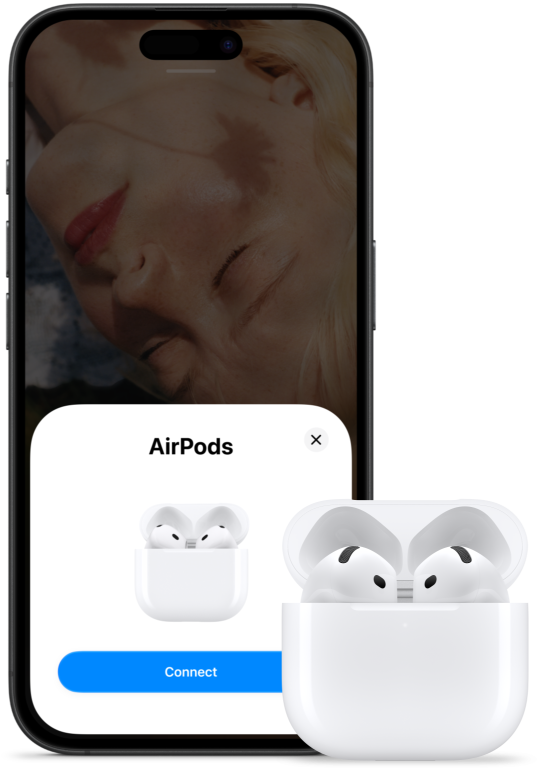 Uma caixa de carregamento aberta com os AirPods 5, ao lado de um iPhone, a mostrar que estes foram ligados.