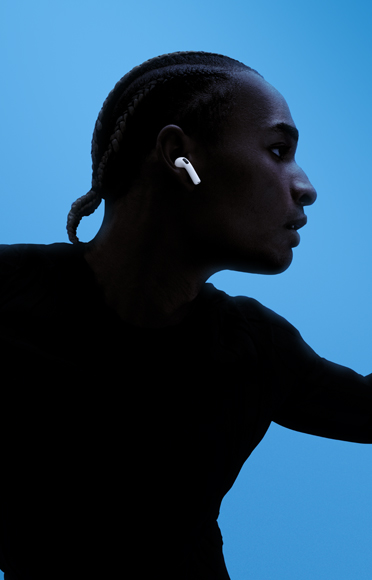 AirPods 5 takmış bir kişi, kolları açık, renkli arka plan