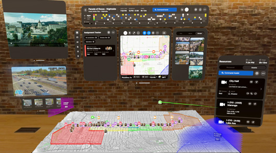 Représentation 3D de tableaux de bord pour secouristes montrant des vidéos en direct de caméras de surveillance, les affectations des équipes et la carte 3D du parcours d’un défilé, le tout devant un mur de brique dans un bureau